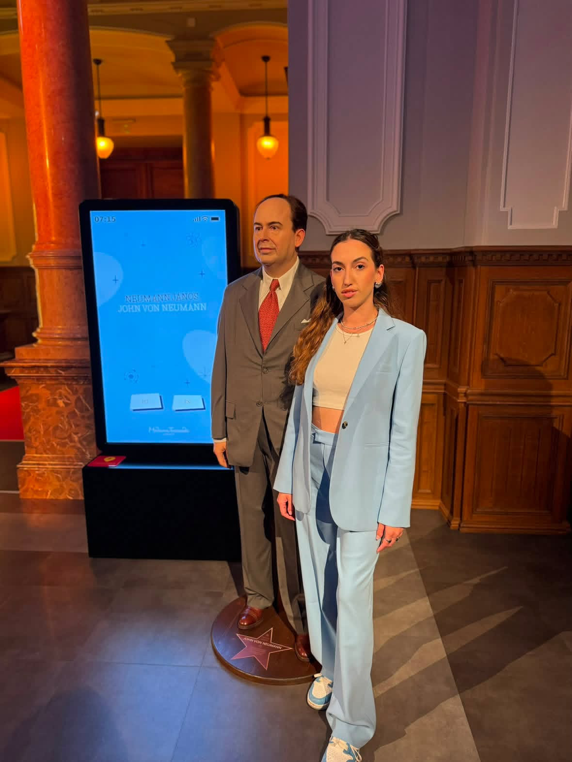 Sotiria Chatzimarkou standing next to a John von Neumann wax figure at Madame Tussauds in Budapest
