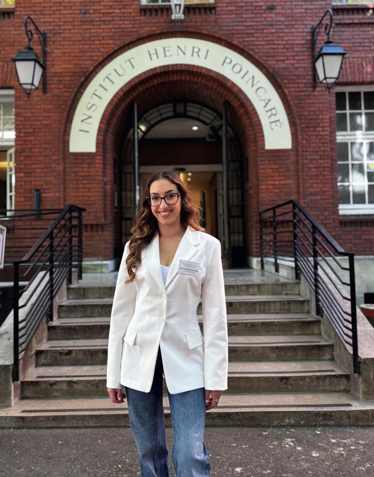 Sotiria Chatzimarkou standing in front of the Institut Henri Poincaré in Paris